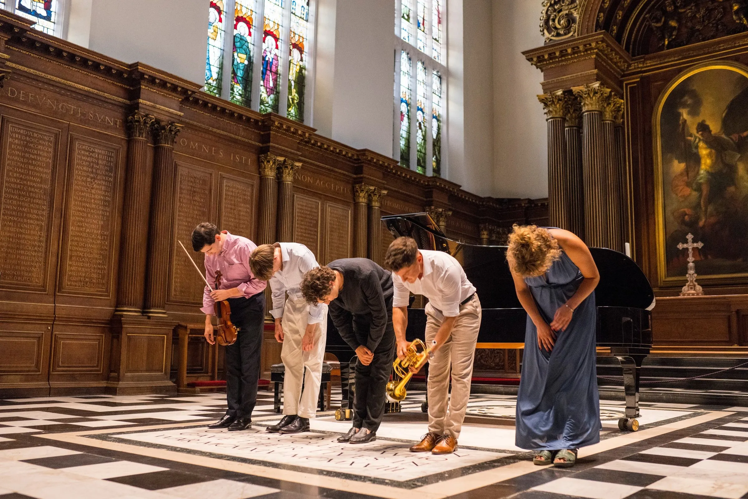 Five performers take a bow on the chequered chapel floor
