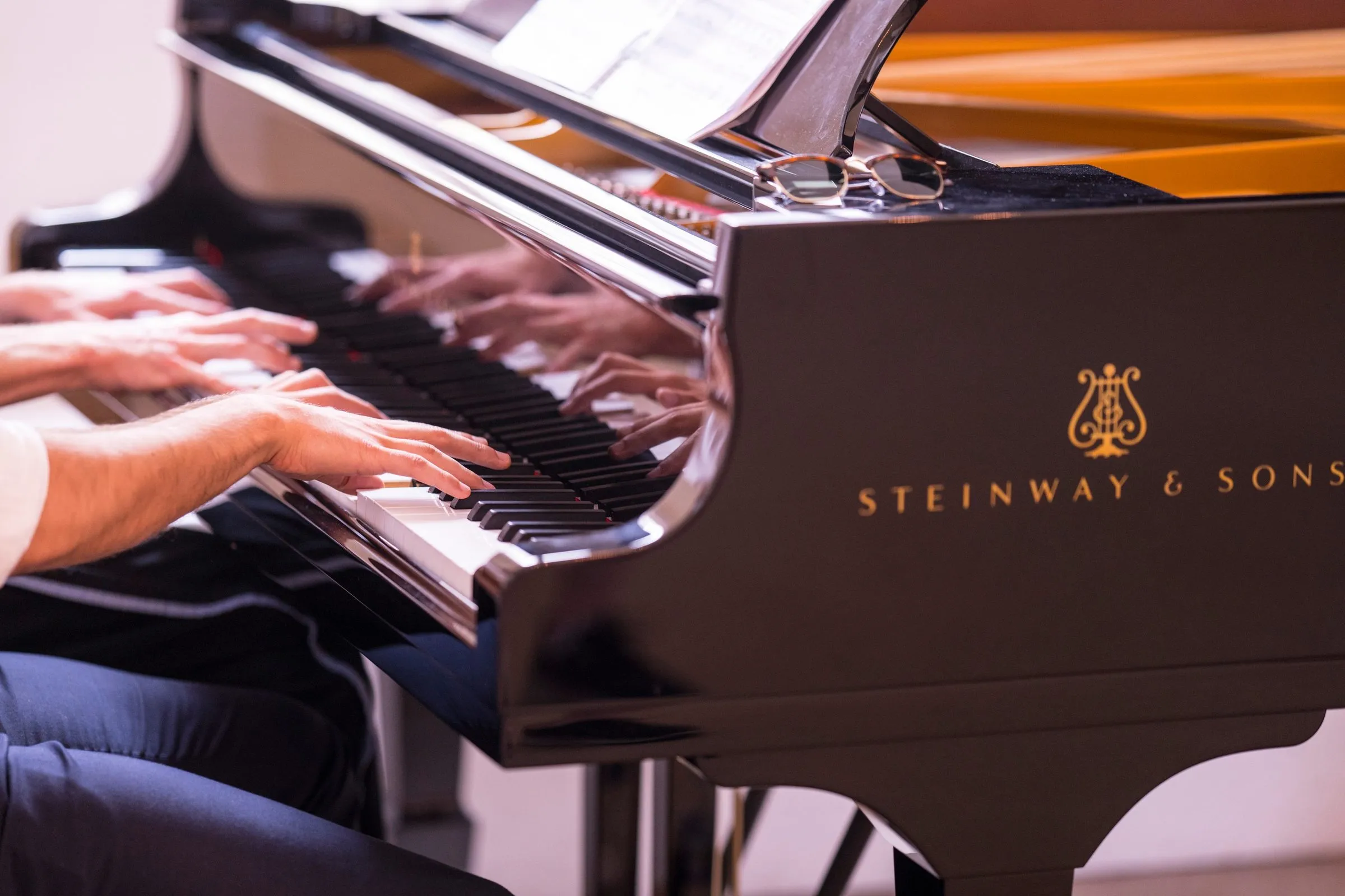 A pianist's hands on the keys of the Steinway