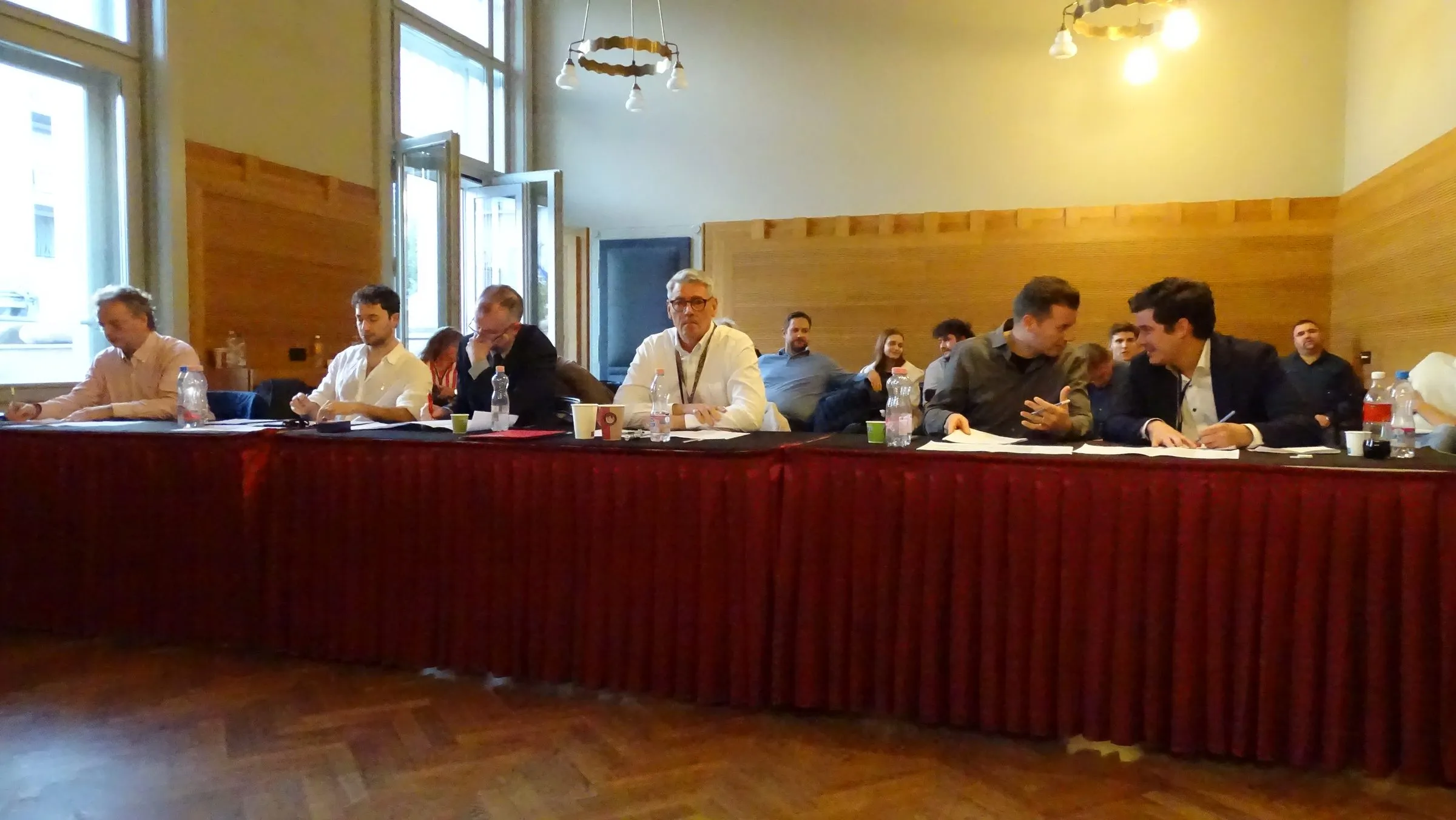 The jury at a red-draped table during the competitions
