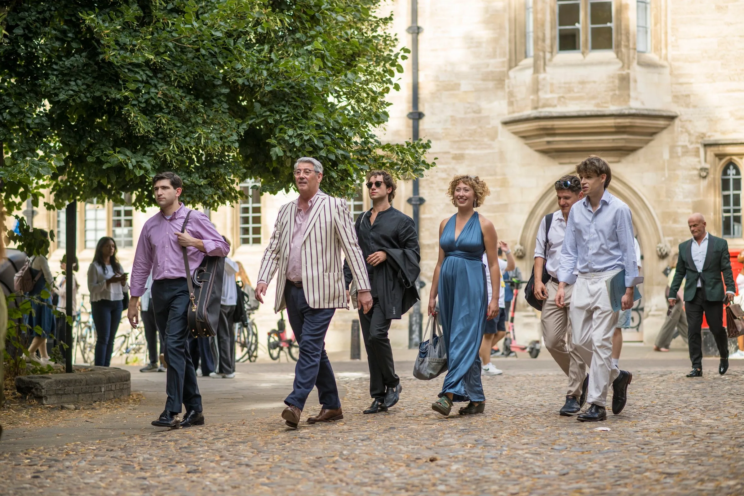 Musicians and audience walking through college after a DYMF summer concert