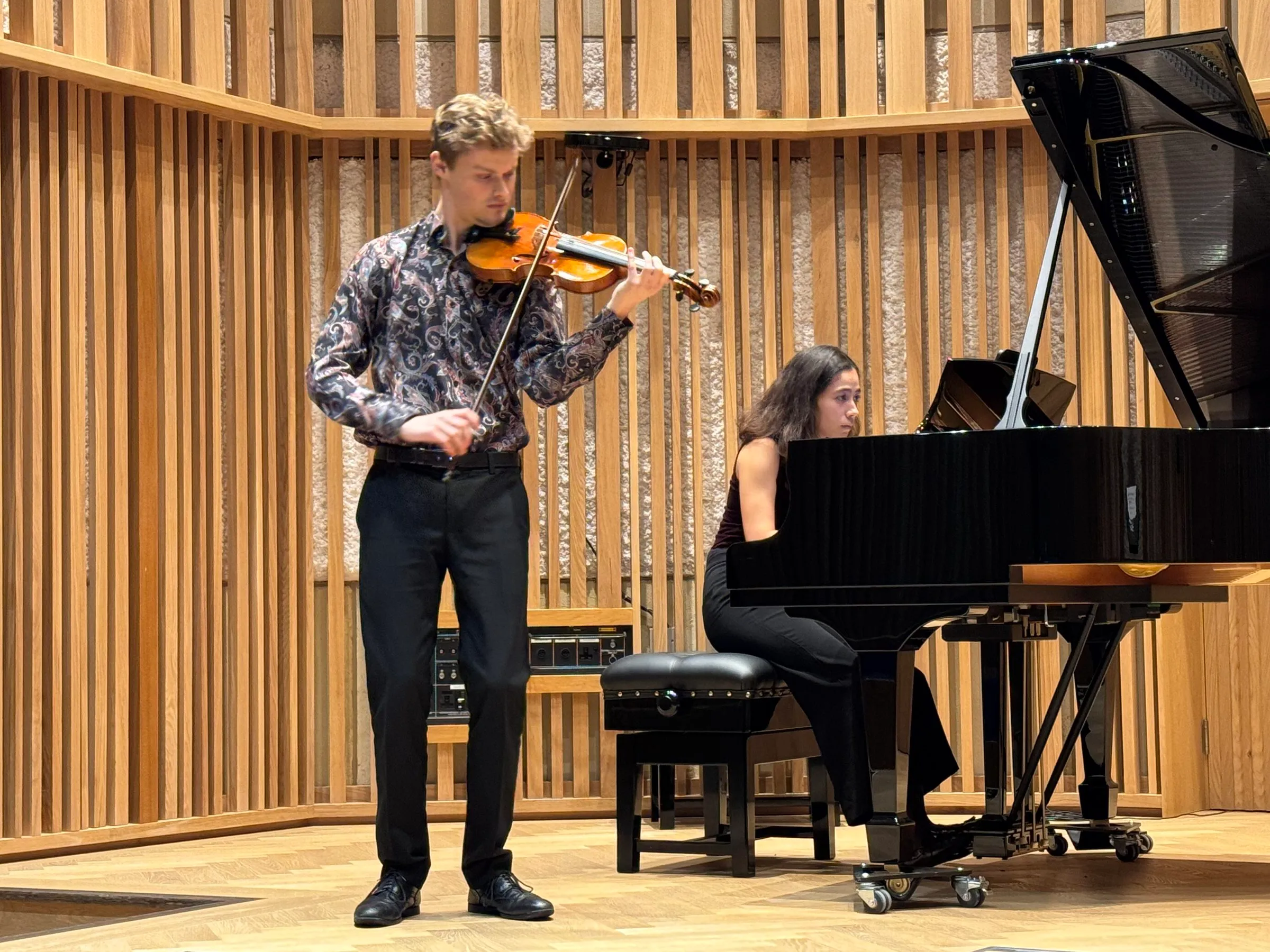 A violinist and pianist perform in the New Space Recital Hall, New College